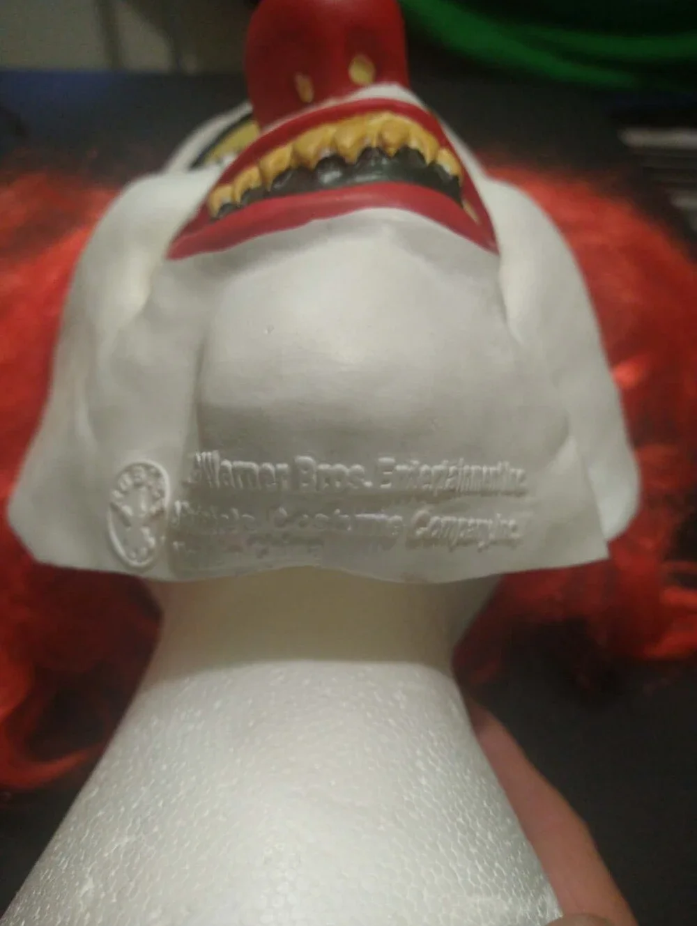 Warner Bros. / Rubie’s scary clown latex mask with bright red synthetic hair